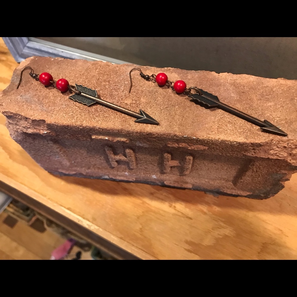 Hanging arrow earrings with red bead accent